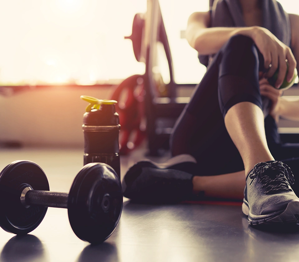 women-siting-next-to-a-dumbbell