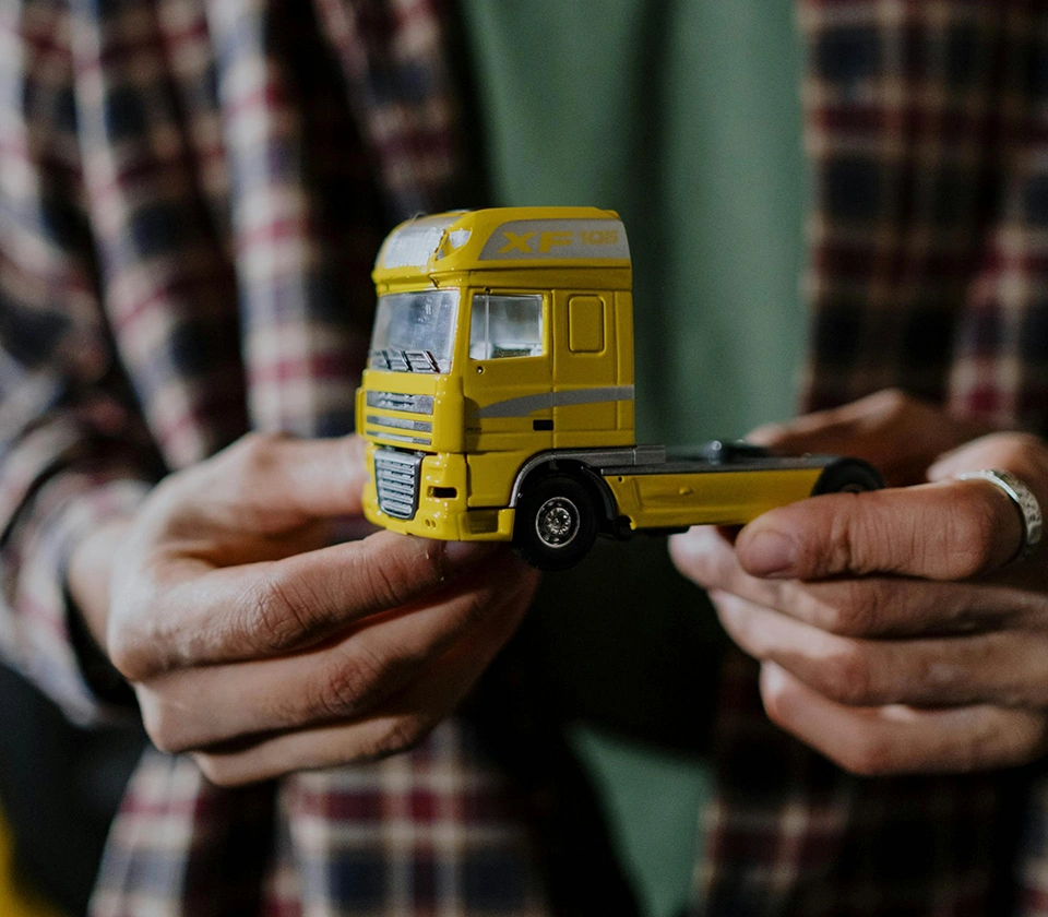 man-holding-truck-toy