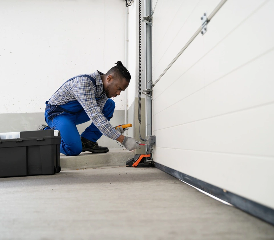 a-man-doing-garage-door-repairing